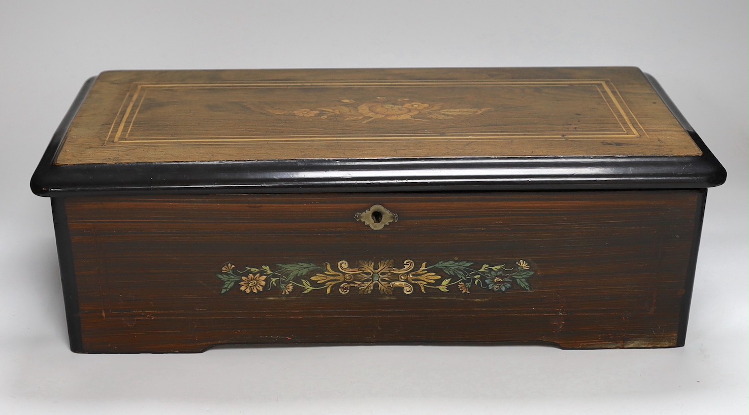 A late 19th century Swiss rosewood and marquetry cased cylinder music box, playing six airs, lacking tune sheet, 43cms wide x 14cms high